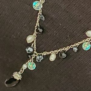 Cookie Lee silvertone Y necklace with faux pearls and black and iridescent beads